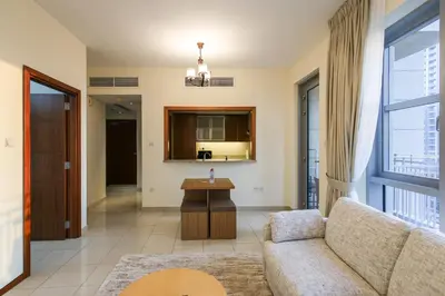 a living room with a couch and a table at Stylish 1BR in Downtown - 5 Min to Burj & Mall in Dubai