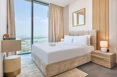 a bedroom with a large bed and a large window at STAY BY LATINEM Luxury 1BR Holiday Home CA 1509 Near Downtown in Dubai