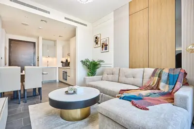 a living room with a couch and a table at STAY BY LATINEM Luxury 1BR Holiday Home CA 1509 Near Downtown in Dubai
