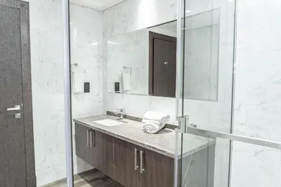 a bathroom with a sink and a mirror at Stylish Stay with Rooftop Pool and Gym, Close to Dubai's Top Sights in Dubai