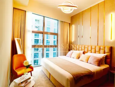 a bedroom with a bed and a large window at Barsana - Lavish 3BR Retreat - Marina & Sea Views in Dubai