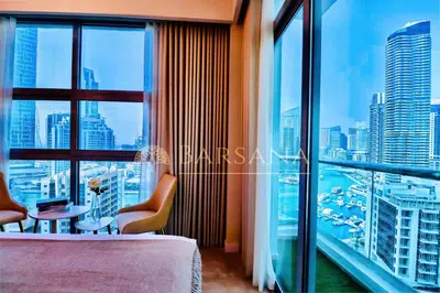 a hotel room with a view of a city at Barsana - Lavish 3BR Retreat - Marina & Sea Views in Dubai