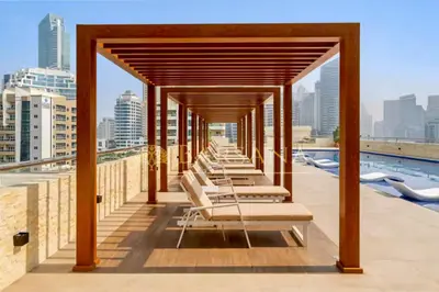 a row of lounge chairs on the roof of a building at Barsana - Lavish 3BR Retreat - Marina & Sea Views in Dubai