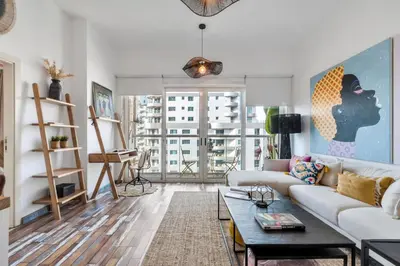 a living room with a couch and a table at The Smart Concierge - Marina view in Dubai
