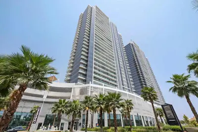 a tall building with palm trees in front of it at PVH - Serene Studio with Skyline View - Carson B in Dubai