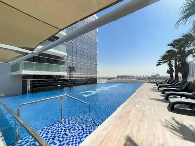 a swimming pool on the side of a building at PVH - Serene Studio with Skyline View - Carson B in Dubai