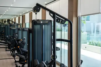 a gym with rows of treadmills and machines at Newly Furnished Studio Haven in Binghatti Azure in Dubai