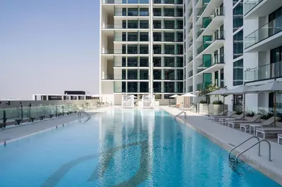 a large swimming pool in the middle of a building at Newly Furnished Studio Haven in Binghatti Azure in Dubai