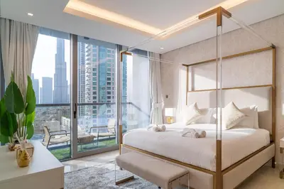 a bedroom with a bed and a large window at Luxury 1 BR At The Sterling in Dubai