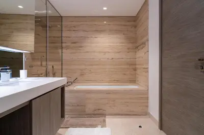 a bathroom with a shower and a bath tub at Luxury 1 BR At The Sterling in Dubai