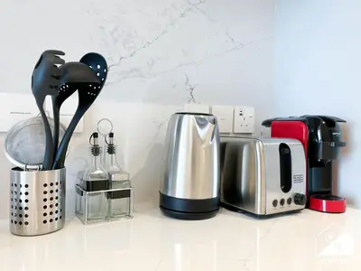 a kitchen counter with a coffee maker and a toaster at Comfort Studio in Meydan With Gym, Pool & Parking in Dubai