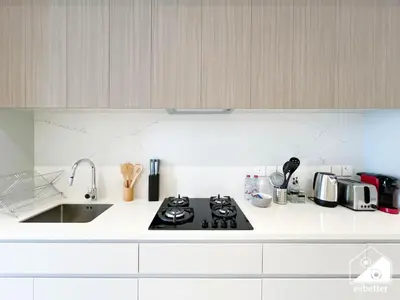 a white kitchen with a stove and a sink at Comfort Studio in Meydan With Gym, Pool & Parking in Dubai