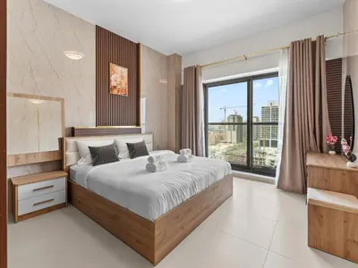 a bedroom with a large bed and a large window at BLVD - Scenic View Stay with Pool and Gym Access in Dubai