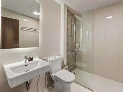 a bathroom with a toilet and a sink and a shower at BLVD - Scenic View Stay with Pool and Gym Access in Dubai