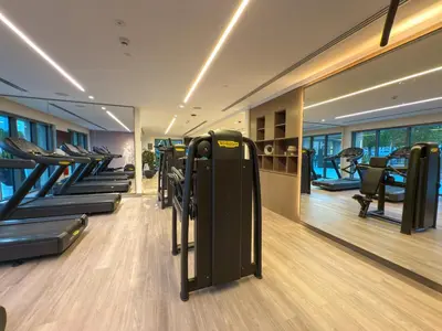 a gym with rows of treadmills and exercise equipment at 4BR Burj & Fountain View Luxe in Dubai