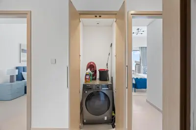 a living room with a washing machine in a room at 4BR Burj & Fountain View Luxe in Dubai