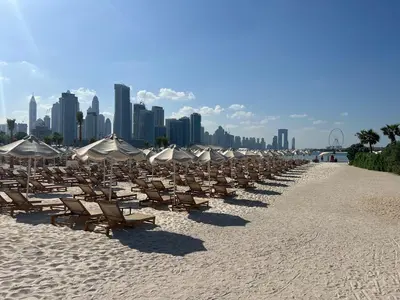 a bunch of chairs and umbrellas on a beach at FullSeaView-RoofTopPool Free Private WestBeachAccess in Dubai