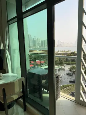 a room with a view of the city from a window at FullSeaView-RoofTopPool Free Private WestBeachAccess in Dubai