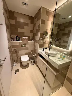 a bathroom with a toilet and a sink at FullSeaView-RoofTopPool Free Private WestBeachAccess in Dubai