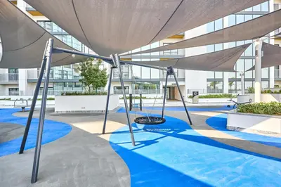 a playground in the courtyard of a building at STAY BY LATINEM Luxury 1BR Holiday Home CB 3607 Near Burj Khalifa in Dubai