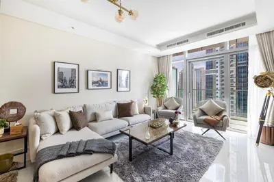 a living room with a couch and a table at Fabulous 2 BR - Paramount Midtown in Dubai
