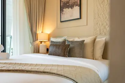 a bedroom with a large white bed with pillows at Canal and Burj Khalifa Views, Few Minutes Drive to Downtown Dubai and 15 Minutes Drive to Kite Beach, Binghatti Canal, Business Bay by Deluxe Holiday Homes in Dubai