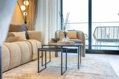 a living room with a couch and a table at Canal and Burj Khalifa Views, Few Minutes Drive to Downtown Dubai and 15 Minutes Drive to Kite Beach, Binghatti Canal, Business Bay by Deluxe Holiday Homes in Dubai