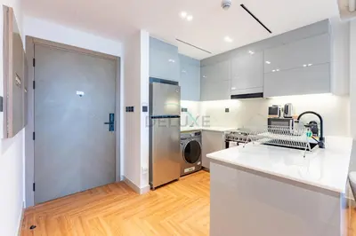 a kitchen with a stainless steel refrigerator and a dishwasher at Canal and Burj Khalifa Views, Few Minutes Drive to Downtown Dubai and 15 Minutes Drive to Kite Beach, Binghatti Canal, Business Bay by Deluxe Holiday Homes in Dubai