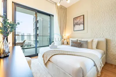 a bedroom with a large white bed and a large window at Canal and Burj Khalifa Views, Few Minutes Drive to Downtown Dubai and 15 Minutes Drive to Kite Beach, Binghatti Canal, Business Bay by Deluxe Holiday Homes in Dubai