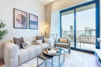 a living room with a couch and a table at Canal and Burj Khalifa Views, Few Minutes Drive to Downtown Dubai and 15 Minutes Drive to Kite Beach, Binghatti Canal, Business Bay by Deluxe Holiday Homes in Dubai
