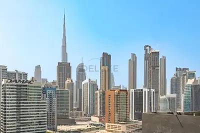 a view of a large city skyline with the tower at Canal and Burj Khalifa Views, Few Minutes Drive to Downtown Dubai and 15 Minutes Drive to Kite Beach, Binghatti Canal, Business Bay by Deluxe Holiday Homes in Dubai