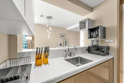 a kitchen with a sink and a counter top at 2BR Midtown Gem - Luxurious Apartment with Balcony in Dubai