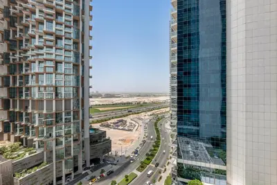 an aerial view of a highway between two tall buildings at 2BR Midtown Gem - Luxurious Apartment with Balcony in Dubai