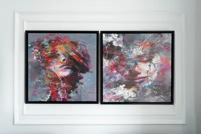 two framed paintings of a woman in a hat at KeyRock - Modern 1BR in Zada with Pool & View in Dubai