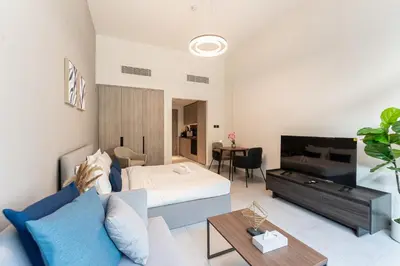 a living room with a bed and a couch at HAVN - Brand New Studio in Oxford Boulevard, JVC in Dubai