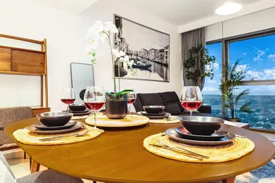 a dining room table with glasses of wine at FIRST CLASS 1BR Modern Comfort in the City in Dubai
