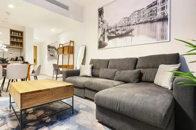 a living room with a couch and a table at FIRST CLASS 1BR Modern Comfort in the City in Dubai