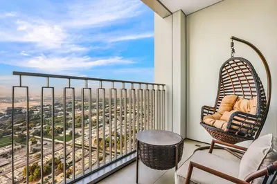 a balcony with a view of a city at Luxury Skyline View 1BR with Pool, Gym, Parking, Concierge & Near Metro in Dubai
