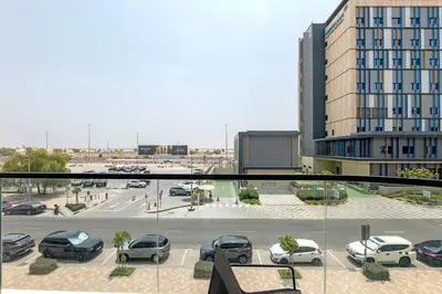 a view of a parking lot with cars parked at Tranquil 1BR Prime Arjan in Dubai