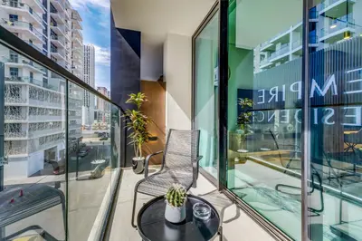 a balcony with a chair and a table at Lush Studio in Binghatti Galaxy in Dubai
