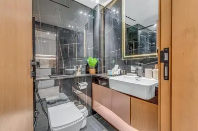 a bathroom with a toilet and a sink at Lush Studio in Binghatti Galaxy in Dubai