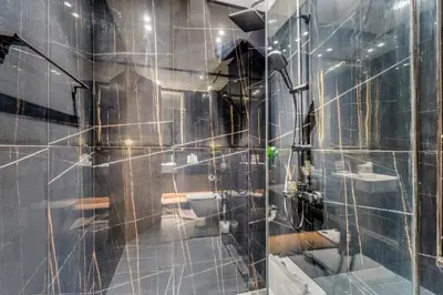 a tiled bathroom with a toilet and sink at Lush Studio in Binghatti Galaxy in Dubai