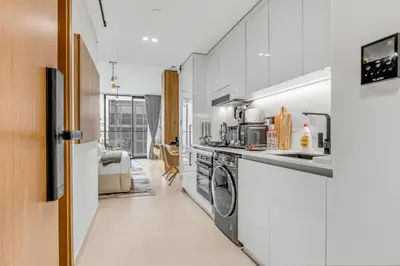 a kitchen with a sink and a stove top oven at Lush Studio in Binghatti Galaxy in Dubai