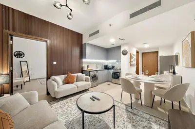 a living room with a couch and a table at FIRST CLASS 1BR Living Garden Luxury and Comfort in Dubai