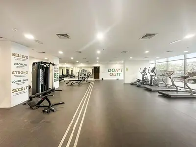 a gym with treadmills and cardio equipment in a building at FIRST CLASS 1BR Living Garden Luxury and Comfort in Dubai