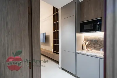 a kitchen with a glass door with an apple on it at Beautiful Brand New Studio in Dubai