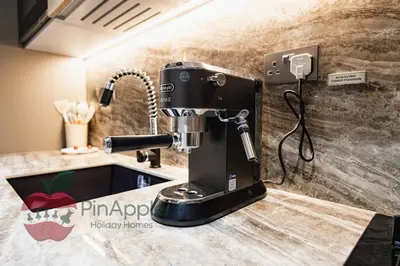 a black mixer sitting on a counter in a kitchen at Beautiful Brand New Studio in Dubai