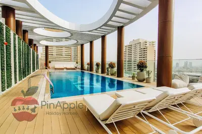 a swimming pool on the roof of a building at Beautiful Brand New Studio in Dubai