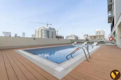a swimming pool on the roof of a building at Vogue JVC Jeewar Tower near Circle Mall, One Bedroom Apartment with Balcony and City View, Access to all Amenities in Dubai