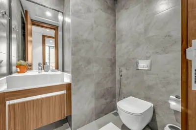 a bathroom with a white toilet and a sink at Brand New Luxury 2 Bedroom in Dubai